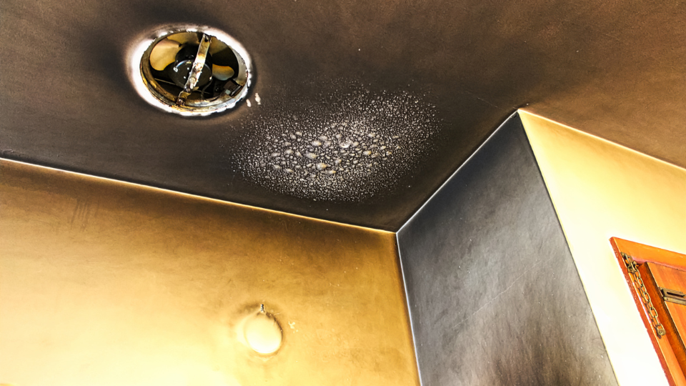 Abstract gold and gray textured surfaces with ceiling details.